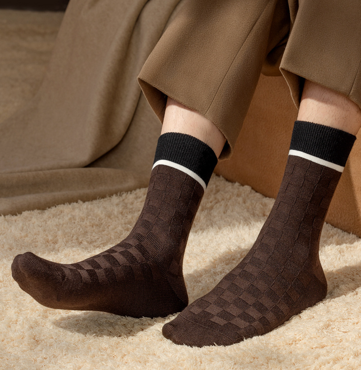 Men's wool dress socks in brown basketweave knit, featuring a white stripe accent. Worn with trousers.