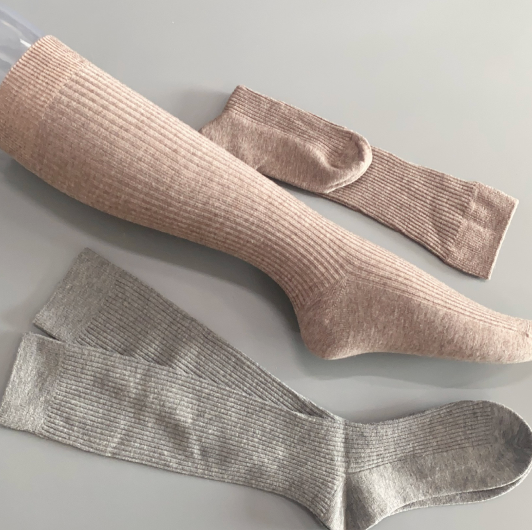 Merino wool boot socks in taupe and grey, featuring a ribbed knit with a buckle accent. Displayed flat to show two color options.