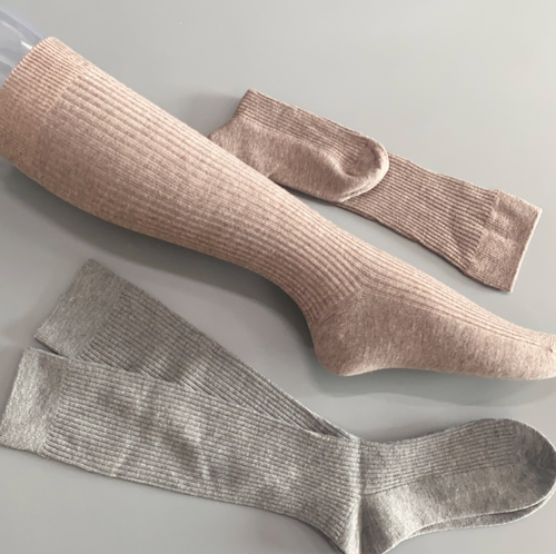 Merino wool boot socks in taupe and grey, featuring a ribbed knit with a buckle accent. Displayed flat to show two color options.