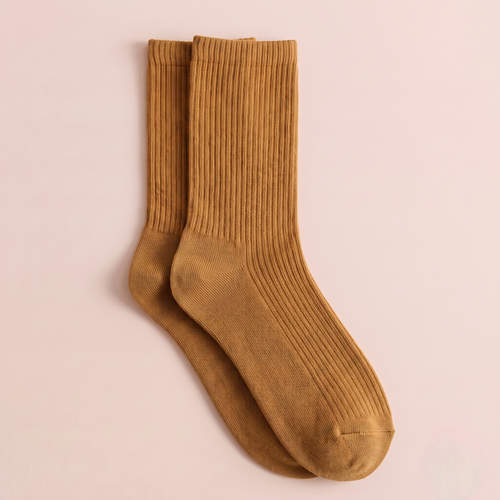 Merino wool dress socks in mustard gold ribbed wool, featuring a warm crew length. Shown as an upright flat-lay pair.