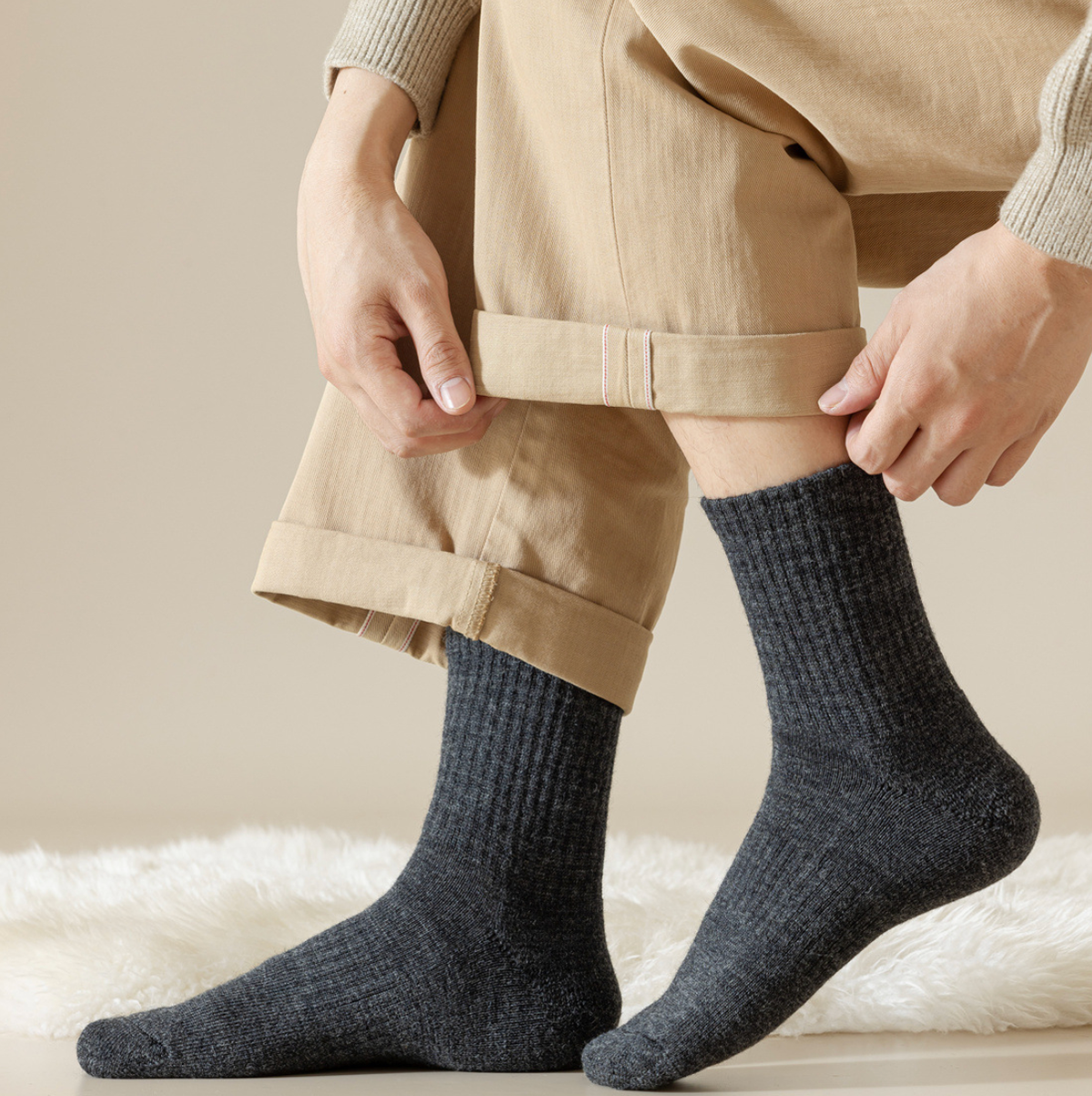 Merino wool quarter socks in charcoal grey, featuring a warm ribbed knit. Worn on feet with khaki trousers.