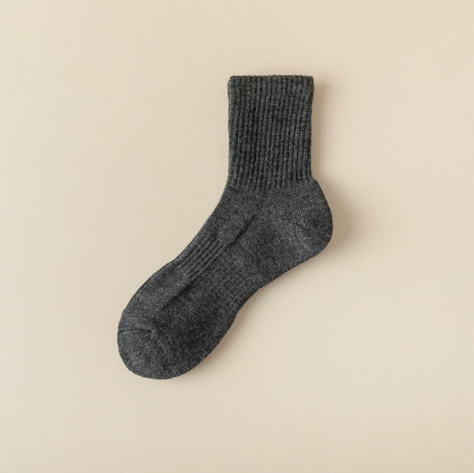 Merino wool quarter socks in dark grey, featuring a soft wool rib. Displayed flat to highlight the quarter length.
