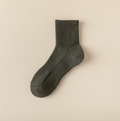 Merino wool quarter socks in olive green, featuring a cushioned ribbed body. Shown as a single flat-lay on a neutral backdrop.