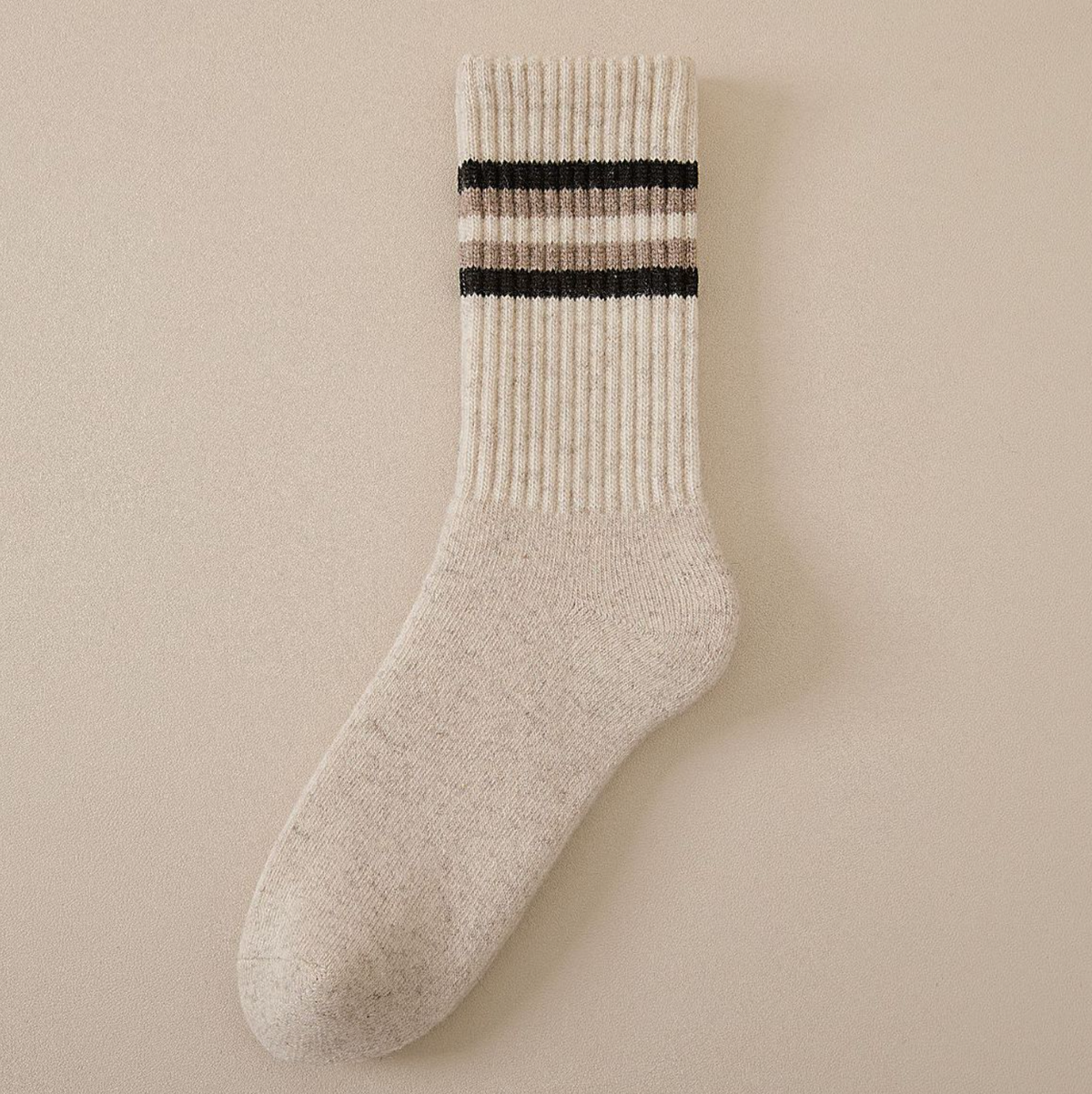 Merino wool thermal socks in cream beige with black stripes, single sock laid flat.