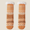 Non-skid slipper socks in mustard Fair Isle knit, featuring a Nordic pattern and grip sole. Shown as a flat-lay pair on a light backdrop.