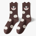 Novelty crew socks in dark brown with white polka dots and a cartoon animal face, featuring a fun motif. Displayed flat as a pair.