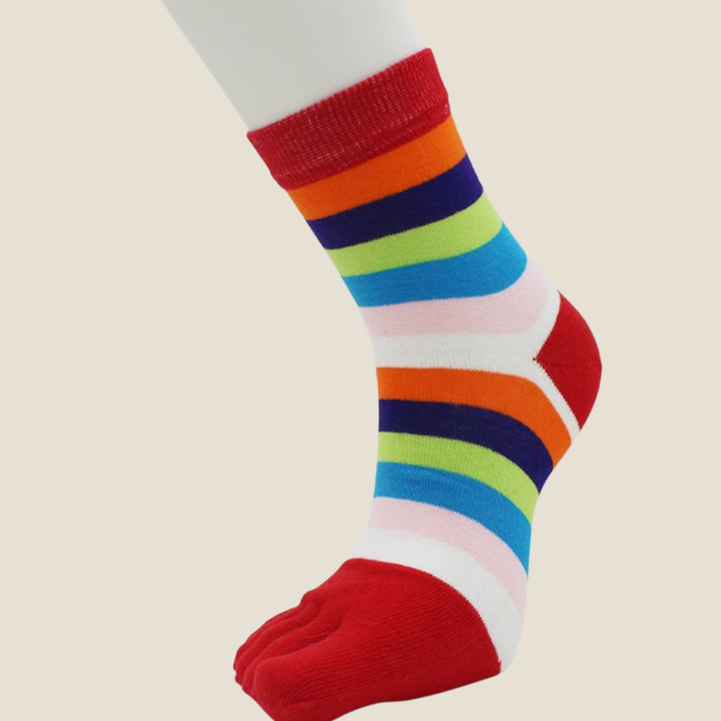 Rainbow toe socks in bright rainbow stripes with red toes, featuring a five-toe design. Worn to show the colorful pattern.