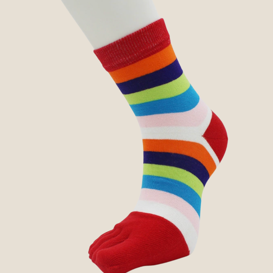 Rainbow toe socks in bright rainbow stripes with red toes, featuring a five-toe design. Worn to show the colorful pattern.