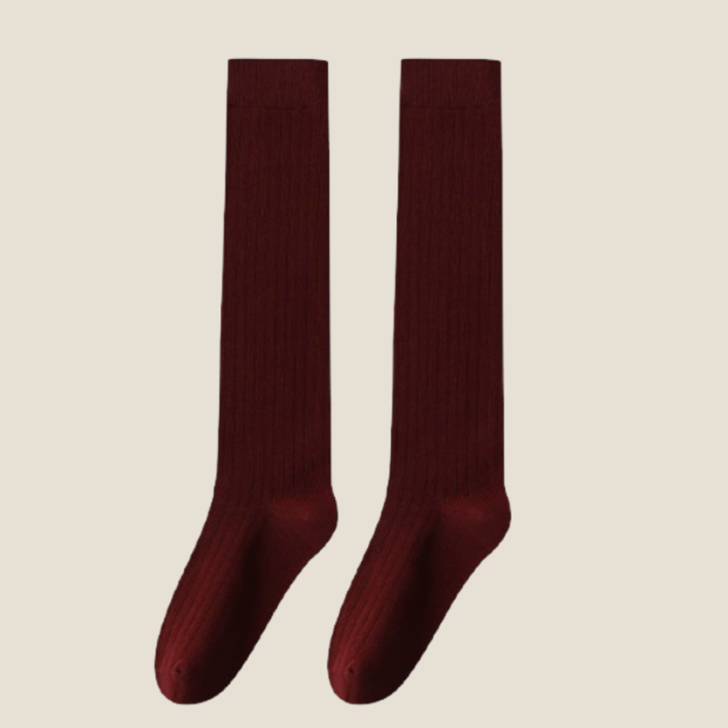 Red high knee socks in deep crimson ribbed knit, featuring a smooth knee-high leg. Shown as an upright flat-lay pair.