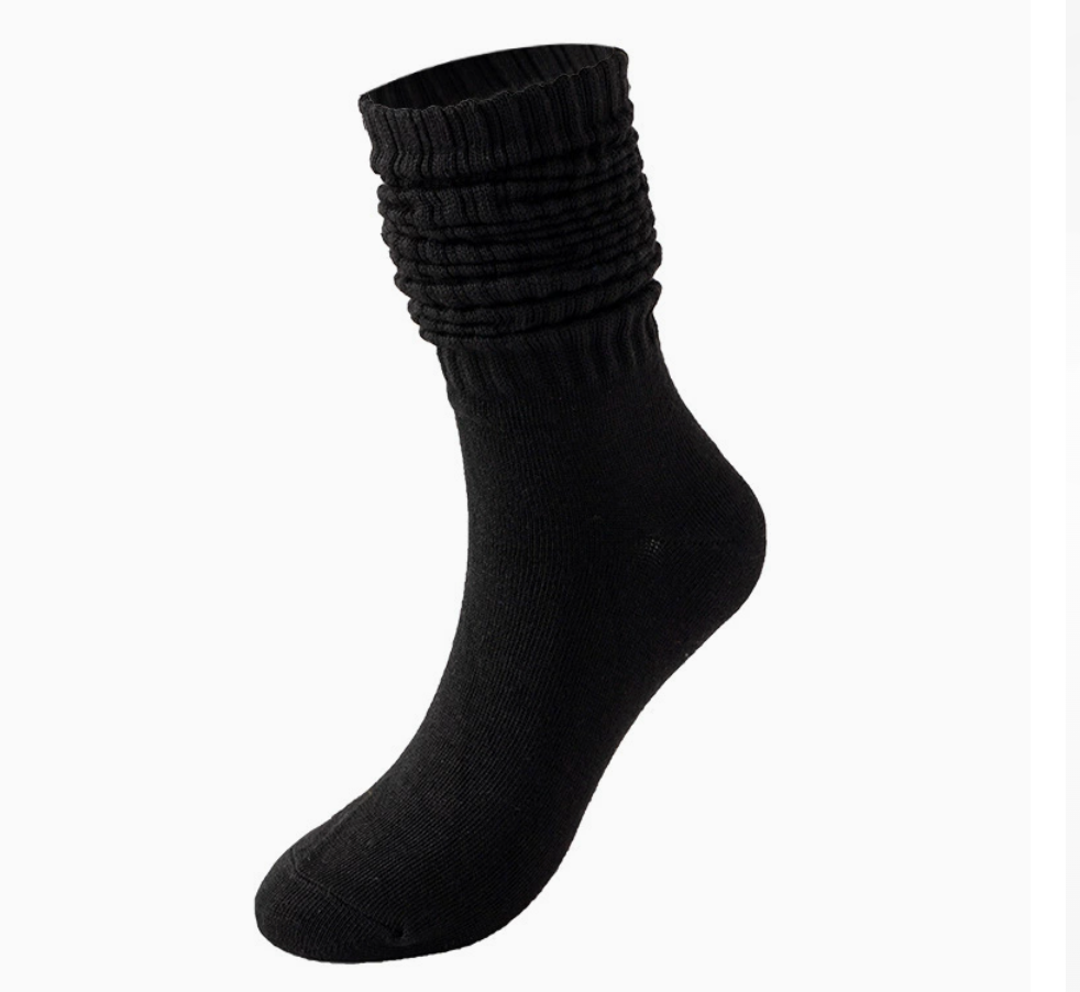 Red slouch socks collection in black knit, featuring a scrunched slouchy leg. Worn on one foot to show the drapey fit.