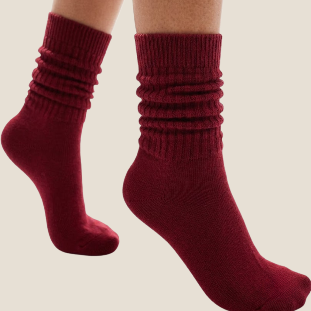 Red slouch socks in burgundy knit, featuring a scrunched slouchy leg. Worn as a pair on the legs.