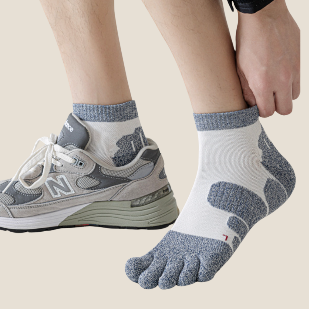 Running toe socks in grey athletic knit, featuring a low ankle cut. Worn with sneakers in an active look.