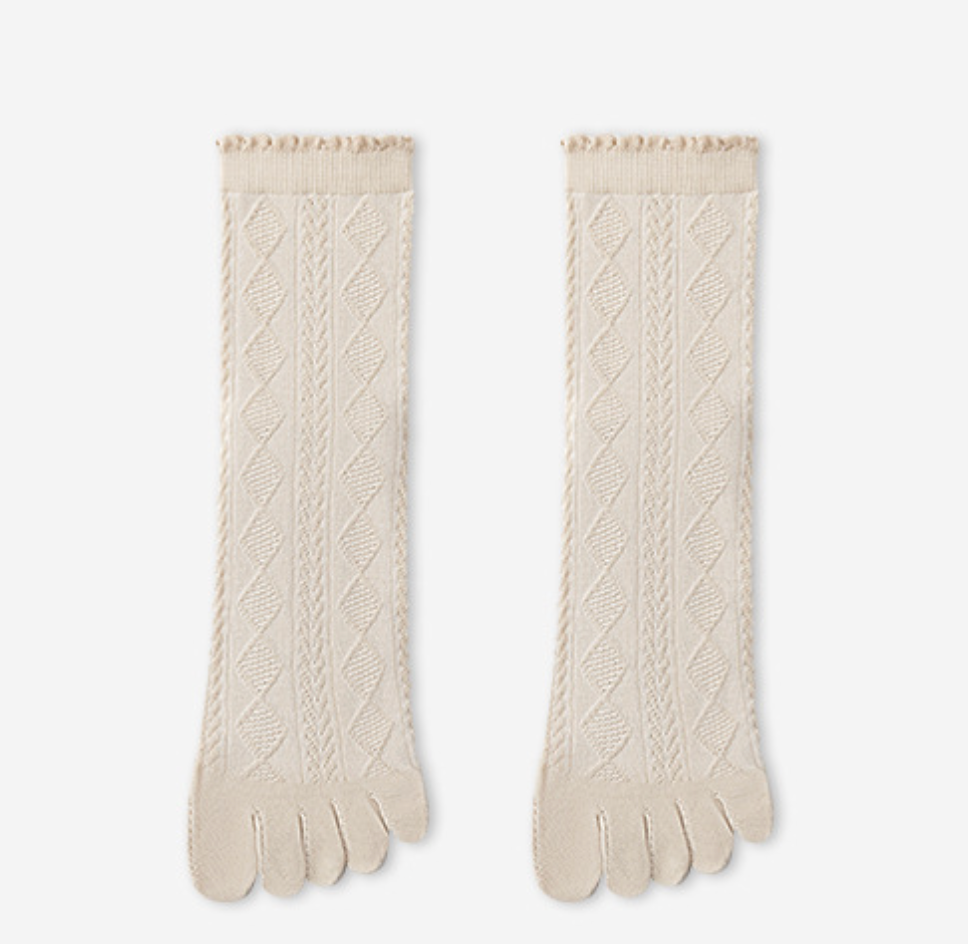 Separate toe socks in cream pointelle knit, featuring a scalloped ruffle cuff. Shown as a flat-lay pair on a light surface.