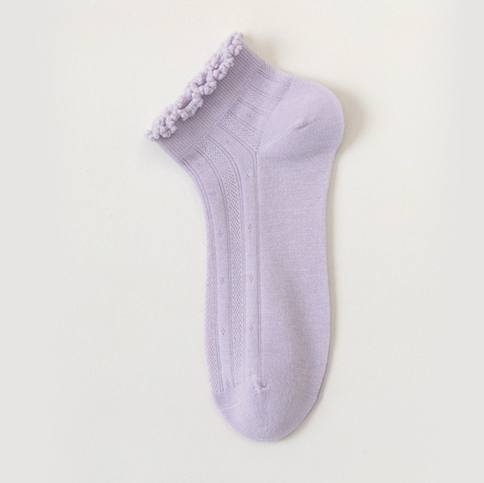 Sheer ankle socks in lilac, featuring a frilled ankle cuff. Laid flat to show the airy knit.