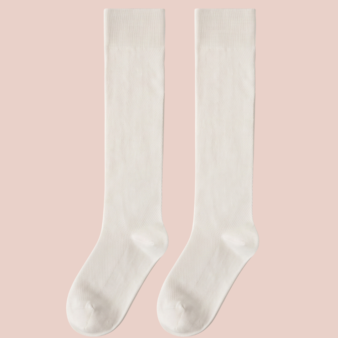 Sheer knee socks in ivory ribbed sheer knit, featuring a fine vertical rib. Shown as a flat-lay pair on a pink surface.