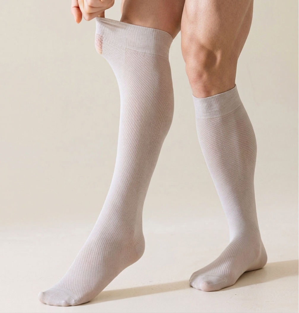 Sheer knee socks in white mesh knit, featuring a lightweight see-through leg. Worn on legs against a soft backdrop.