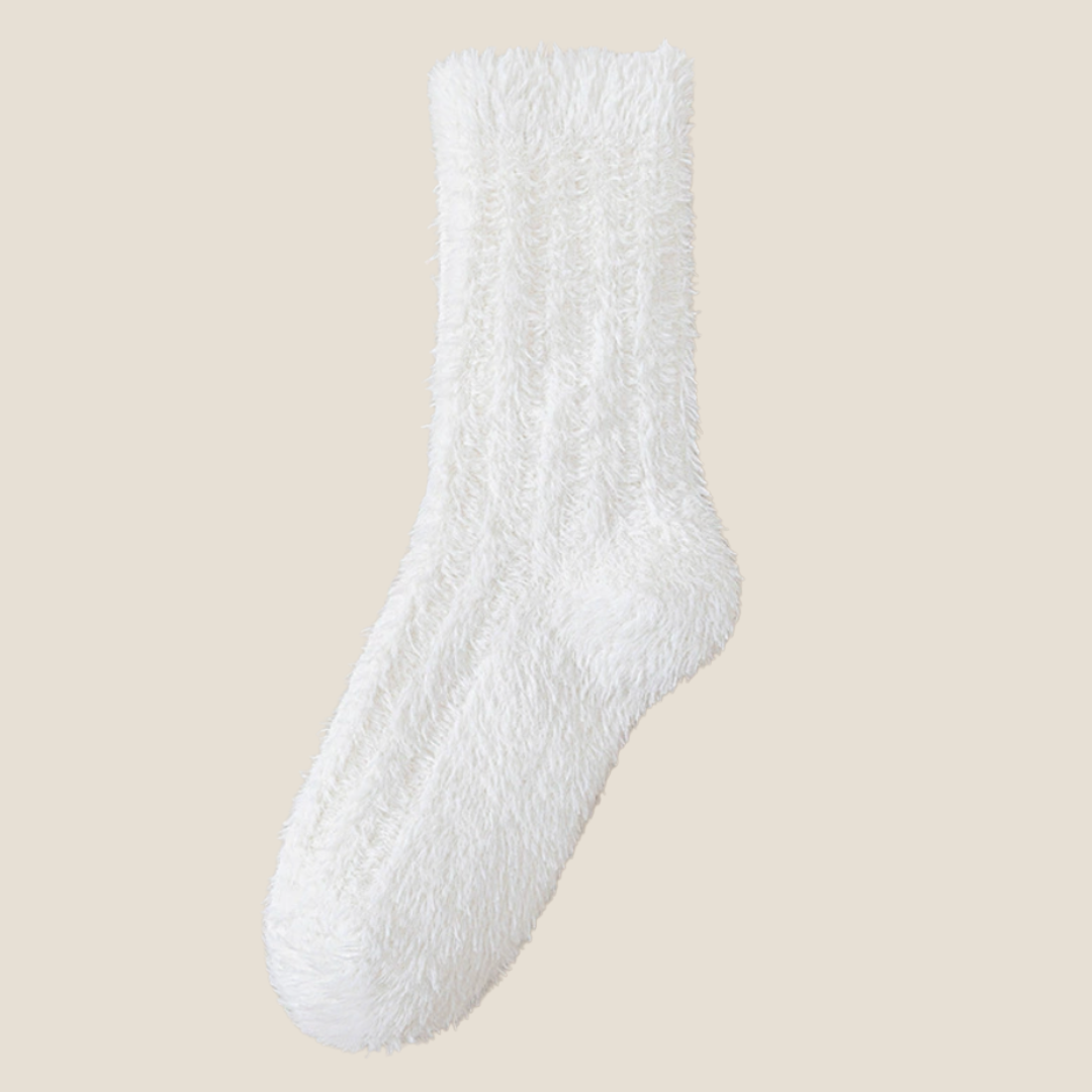 Socks for cold toes in cream fuzzy knit, featuring a snug ribbed cuff. Shown flat to highlight the warm pile.