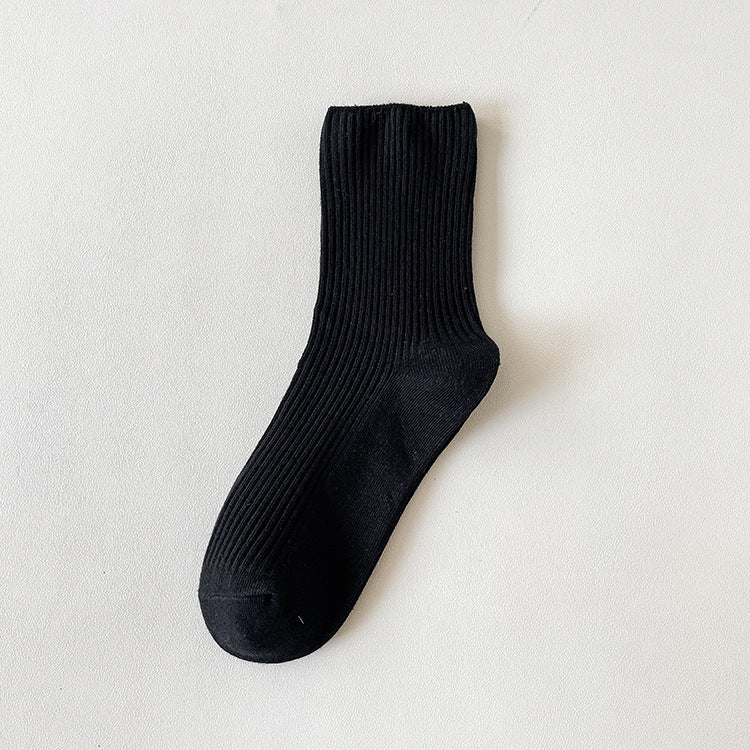 Socks for loafers women in black ribbed cotton, a single sock laid flat on a white background.