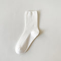 Socks for loafers women in white ribbed cotton, a single sock shown flat to display the vertical rib texture and cuff.