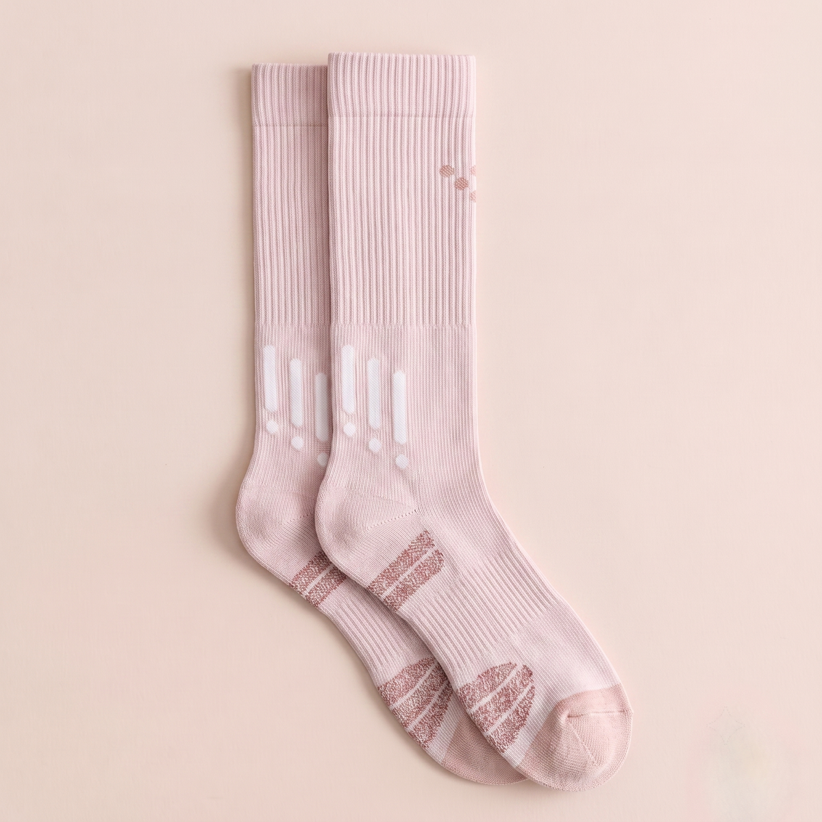 Sport knee socks in pale pink athletic knit, featuring a cushioned ribbed leg. Shown as an upright flat-lay pair.