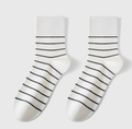 Stripe crew socks in white with black stripes, featuring a soft crew length. Displayed flat as a pair on a light surface.
