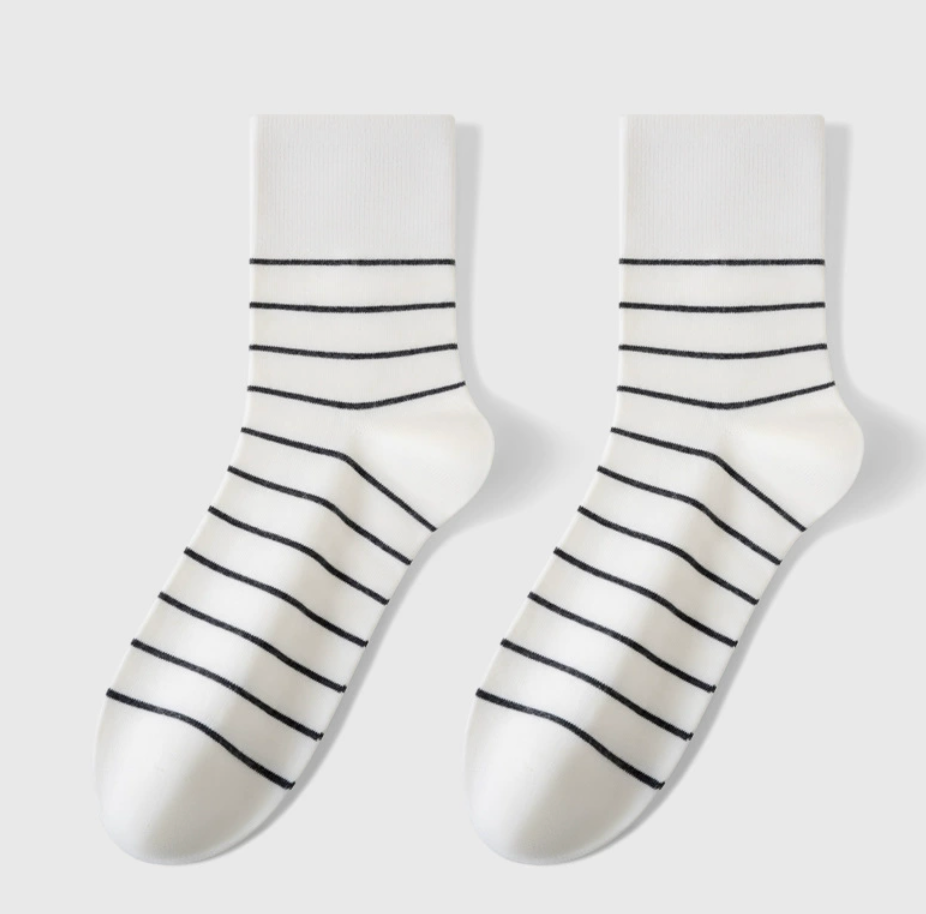 Stripe crew socks in white with black stripes, featuring a soft crew length. Displayed flat as a pair on a light surface.