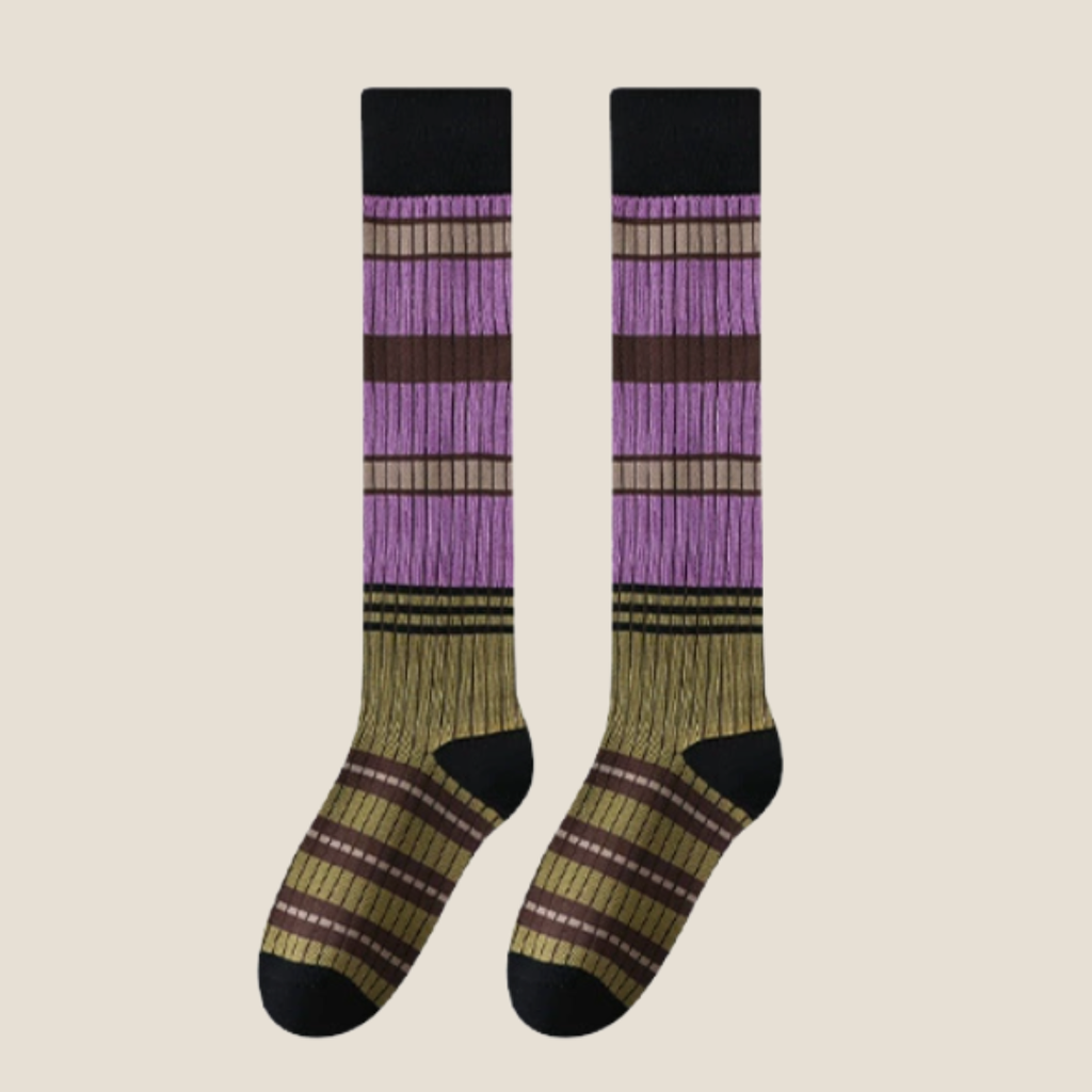 Striped high knee socks in purple, olive and black stripes, featuring a chunky ribbed weave. Displayed flat as a pair on a neutral backdrop.