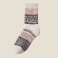 Super warm socks in cream fleece, featuring a grey Fair Isle stripe. Shown flat on a neutral surface.