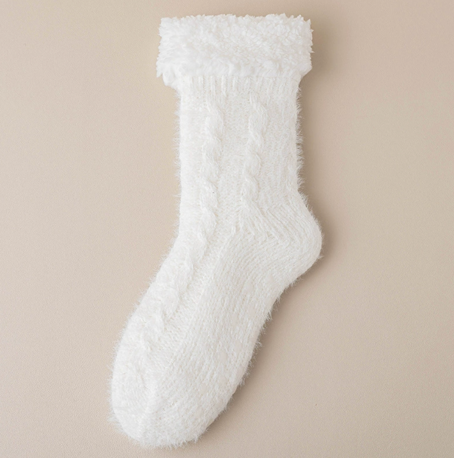 Thermal slipper socks in white, featuring a soft fleece pile. Shown as a single flat-lay on a neutral backdrop.