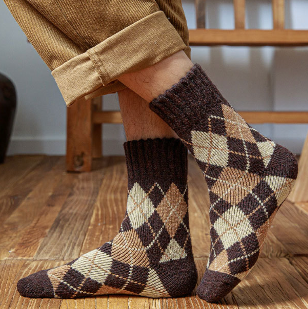 Thermal socks for work in brown and black argyle wool, worn with cuffed khaki trousers, side view.