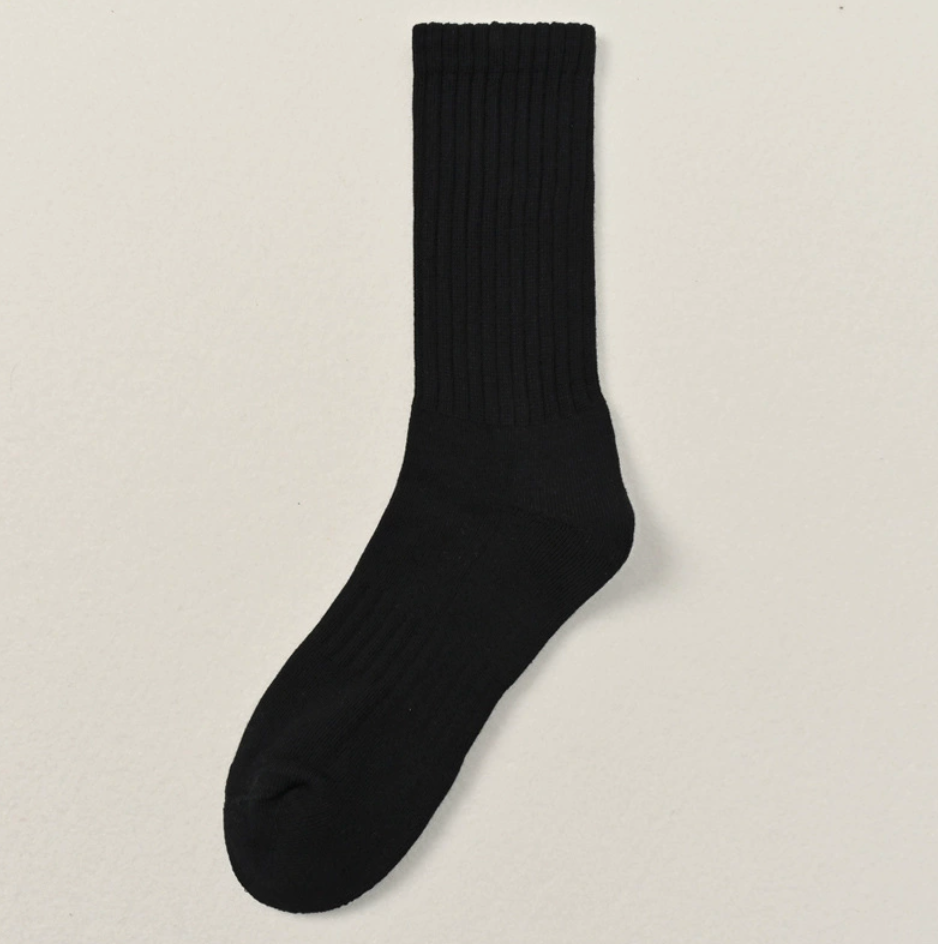 Thick socks business casual in black, featuring a cushioned ribbed body. Shown flat against a neutral surface.