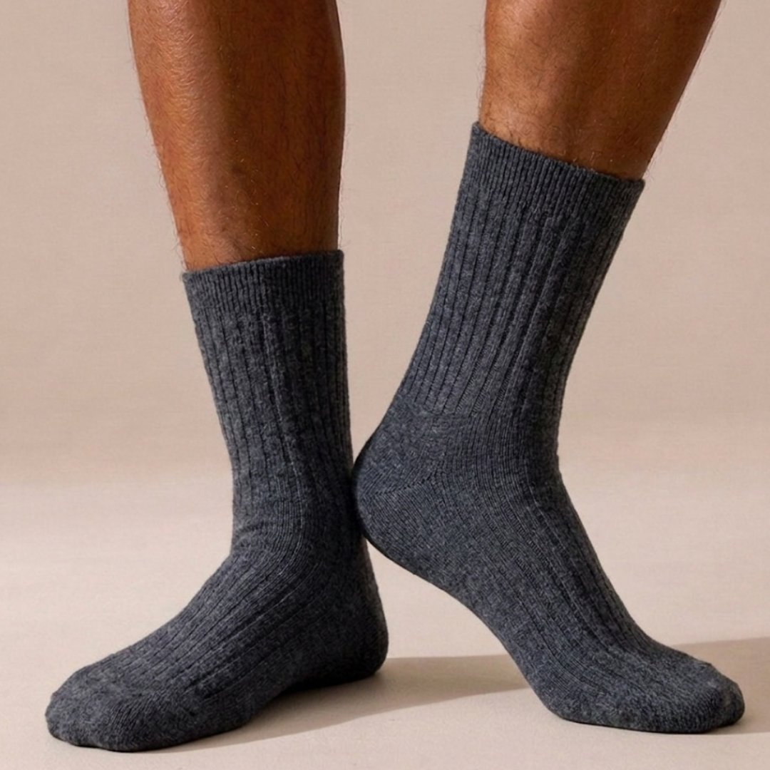 Thick socks business casual in charcoal grey, featuring a fine ribbed knit. Worn on feet for a smart casual look.