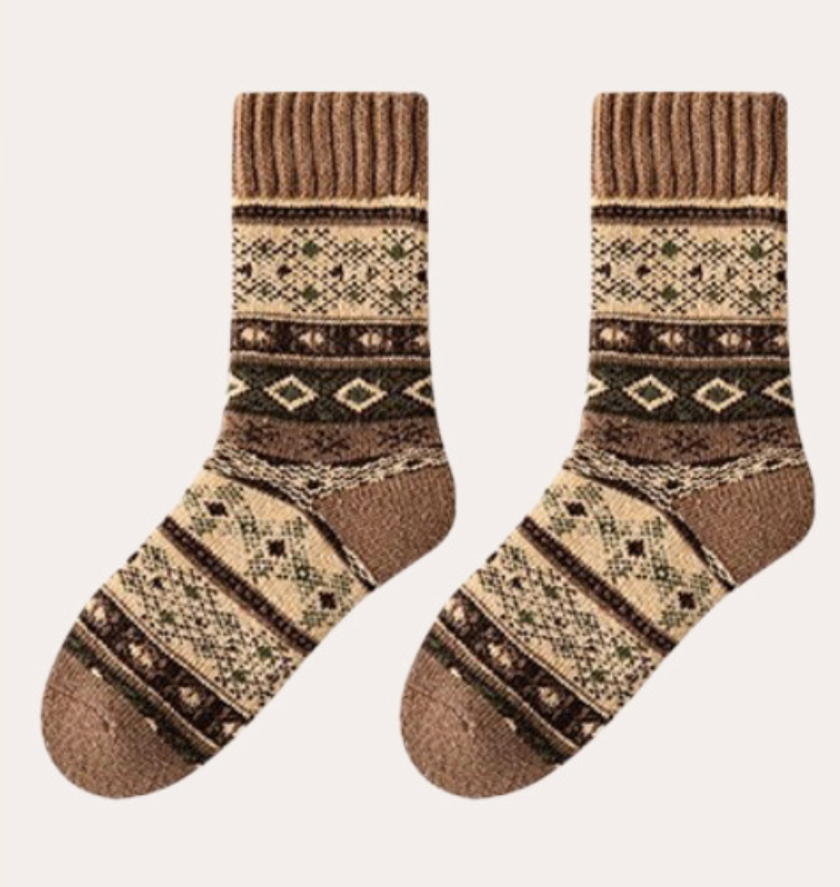 Thick socks for women in warm brown wool, featuring a cream Aztec knit design. Laid flat to display the detailed pattern.