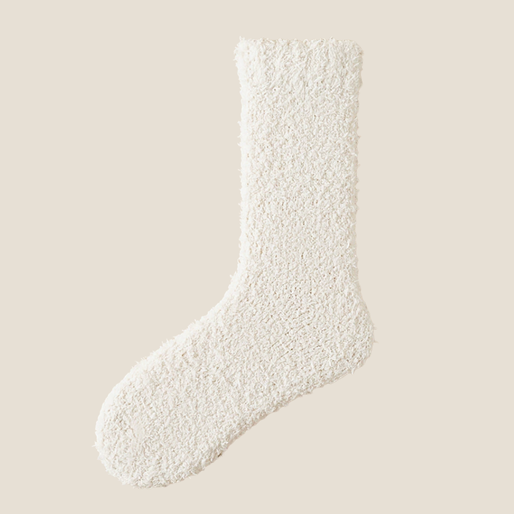 Thick warm socks in ivory fleece, featuring a plush cushioned body. Shown flat against a light backdrop.