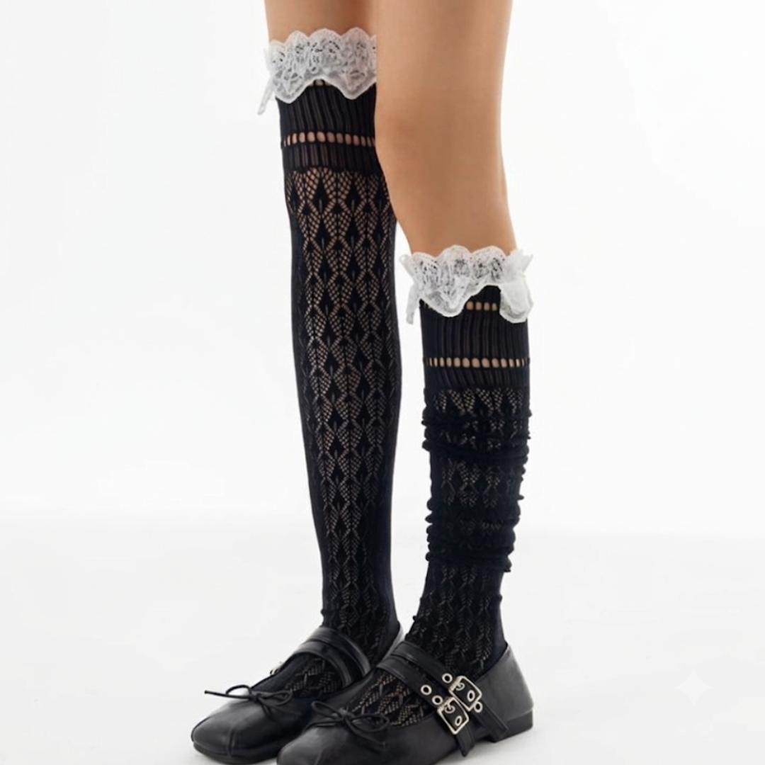 Thigh high cute lace stockings in black openwork knit with a ruffled white lace top, shown over the knee.