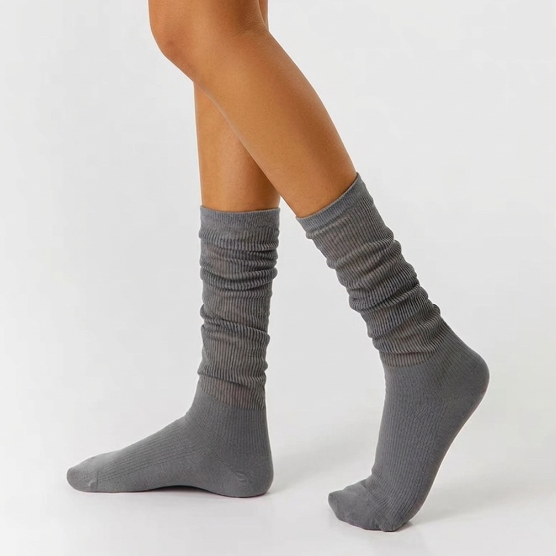 Thin socks for loafers in gray, lightly slouched on the leg and foot, side view showing the thin breathable knit.