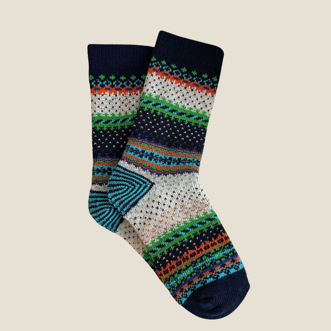 Vintage socks in navy with a multicolor Nordic stripe pattern, single sock shown flat.