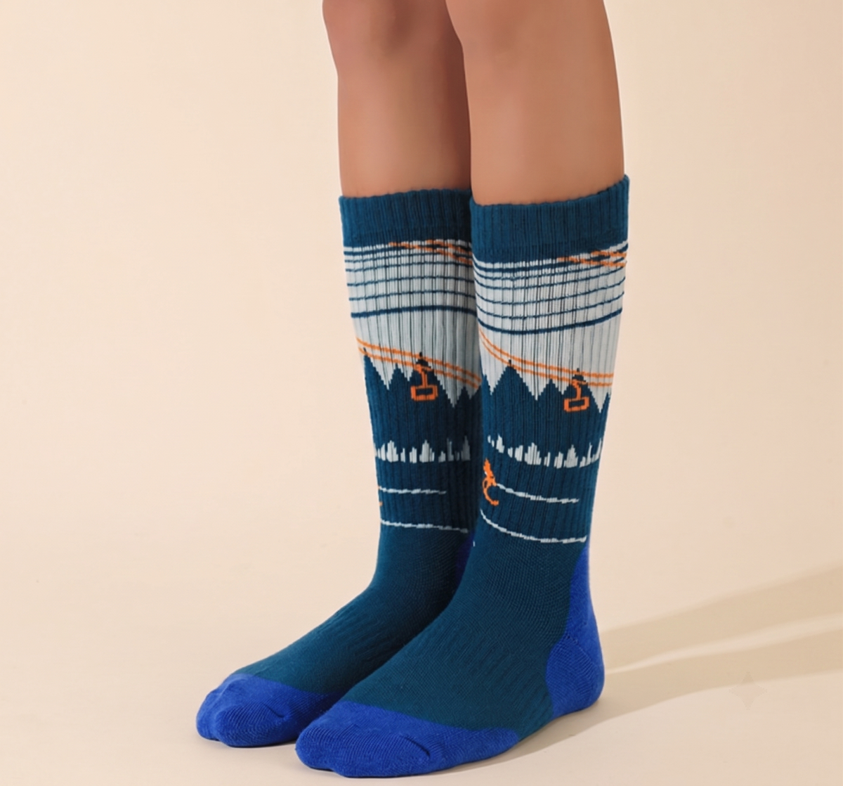 Walking boot socks in teal blue, featuring a mountain landscape design. Worn on legs in an outdoor-inspired look.