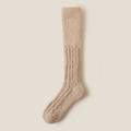 Warm knee high socks in oatmeal fuzzy plush knit, featuring a cozy soft pile. Shown as a single flat-lay on a neutral backdrop.