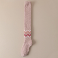 Warm socks for cold feet in soft pink fleece, featuring a rose zigzag accent band. Shown as a single flat-lay against a neutral backdrop.