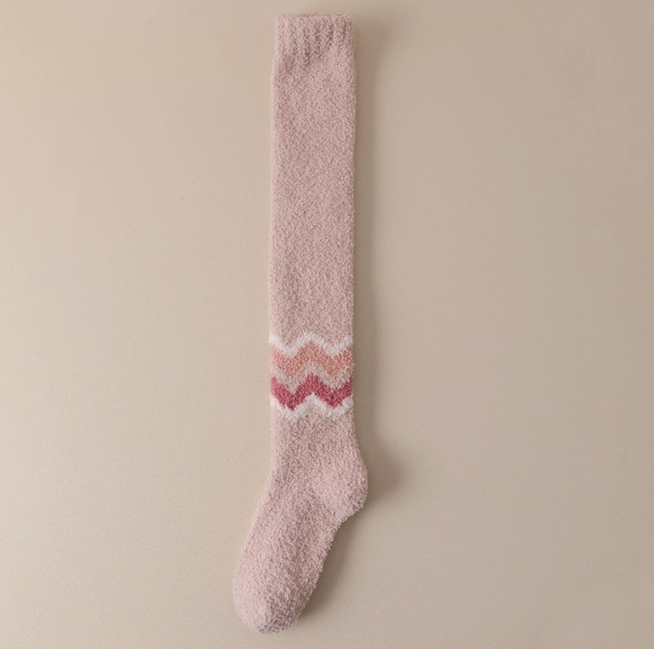 Warm socks for cold feet in soft pink fleece, featuring a rose zigzag accent band. Shown as a single flat-lay against a neutral backdrop.