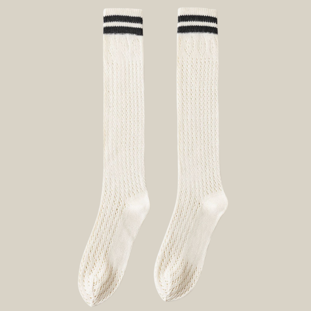 White knee socks with black stripe detail, featuring twin varsity stripes at the cuff. Shown as an upright flat-lay pair.
