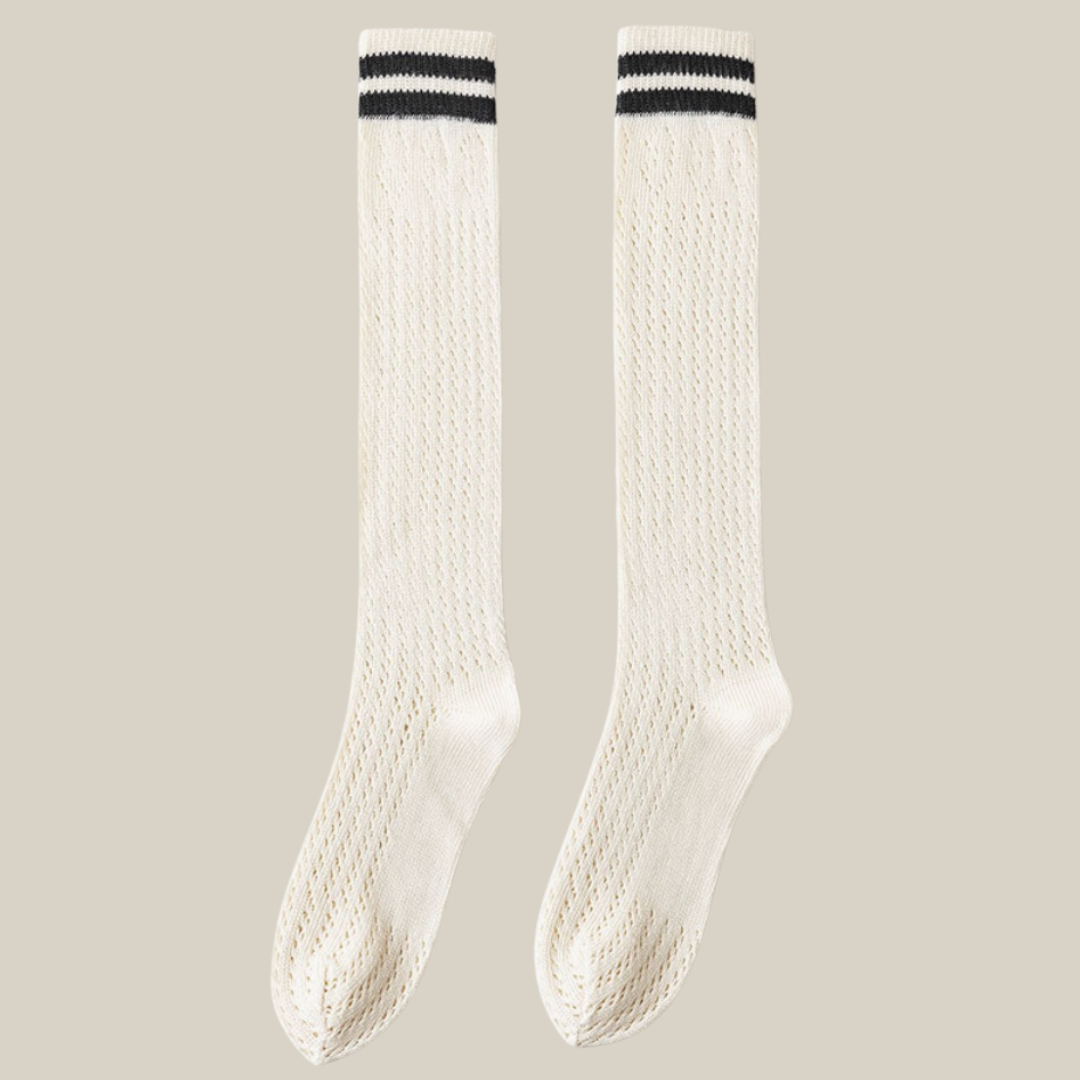 White knee socks with black stripe detail, featuring twin varsity stripes at the cuff. Shown as an upright flat-lay pair.