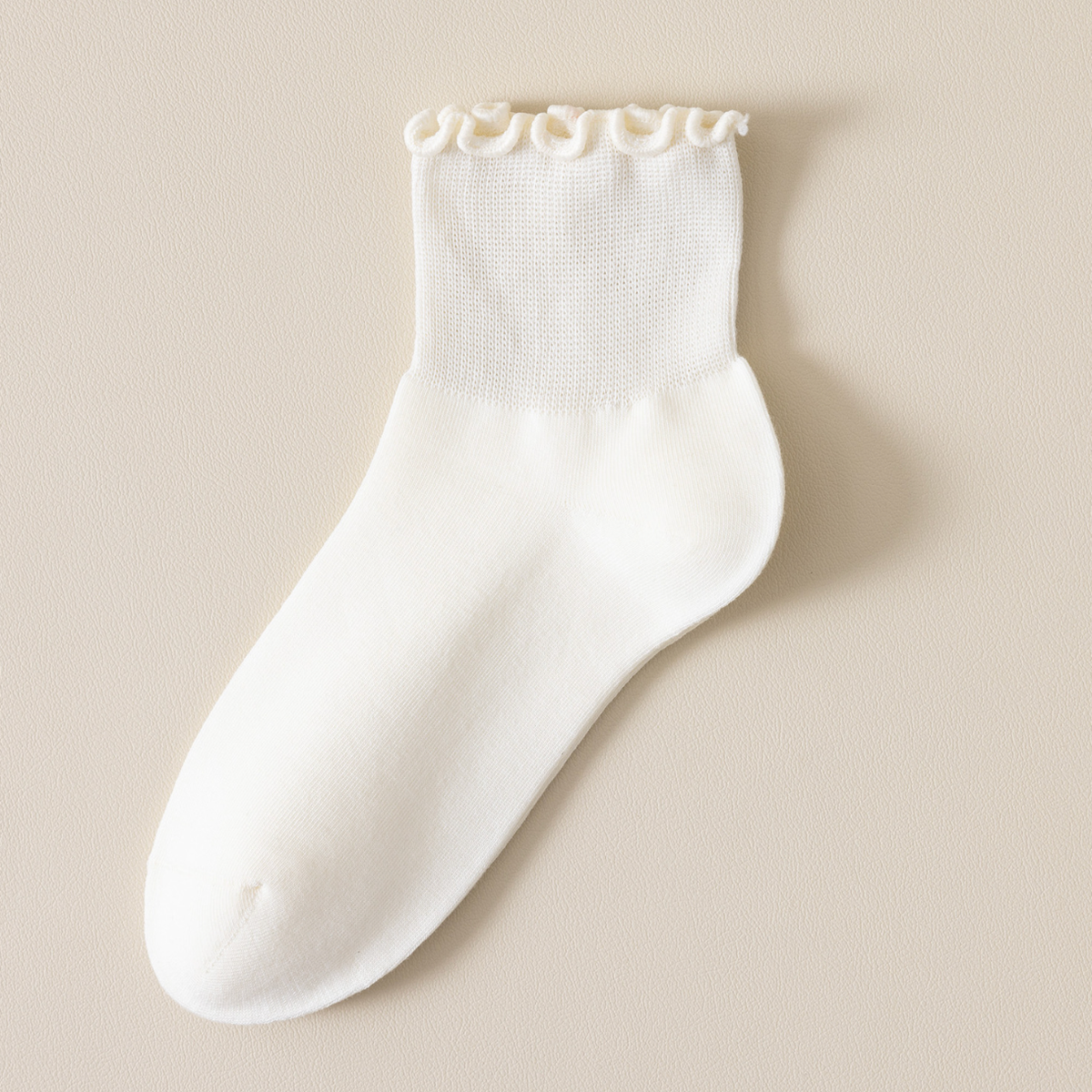 White quarter socks in crisp white, featuring a delicate frill trim. Displayed flat to show the cushioned quarter length.