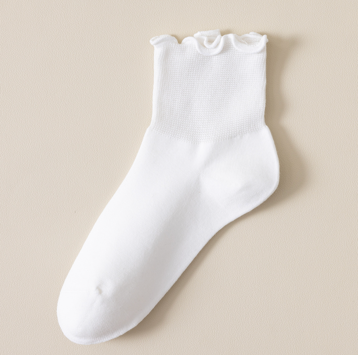 White quarter socks in white, featuring a frilled ruffle cuff. Shown as a single flat-lay on a neutral backdrop.