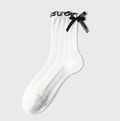 White ruffle socks with a black-edged ruffle and bow, single sock shown flat.