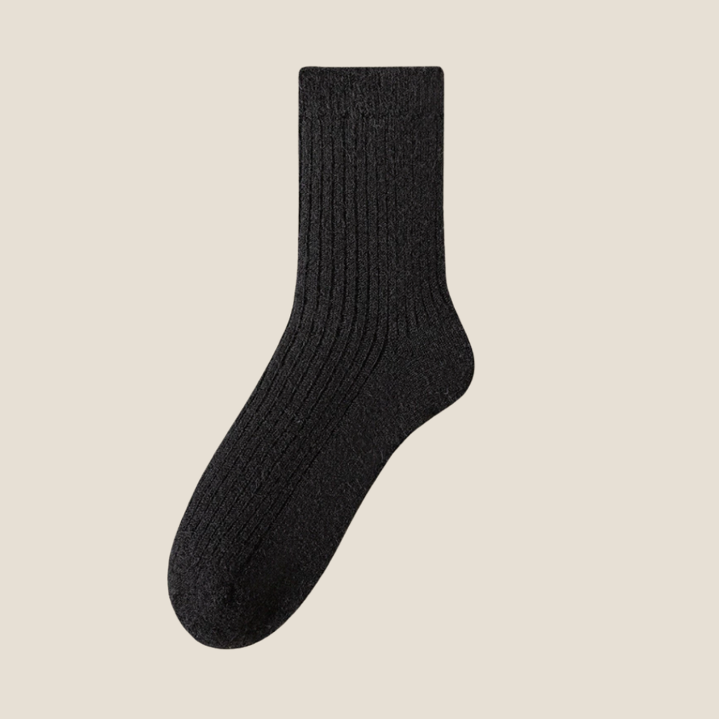 Winter socks for men in black ribbed wool, featuring a dense cushioned knit. Shown standing upright against a neutral backdrop.