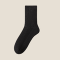 Winter socks for men in black ribbed wool, featuring a dense cushioned knit. Shown standing upright against a neutral backdrop.