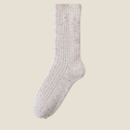 Winter socks for women in oatmeal grey, featuring a flecked ribbed knit. Shown standing upright on a neutral surface.