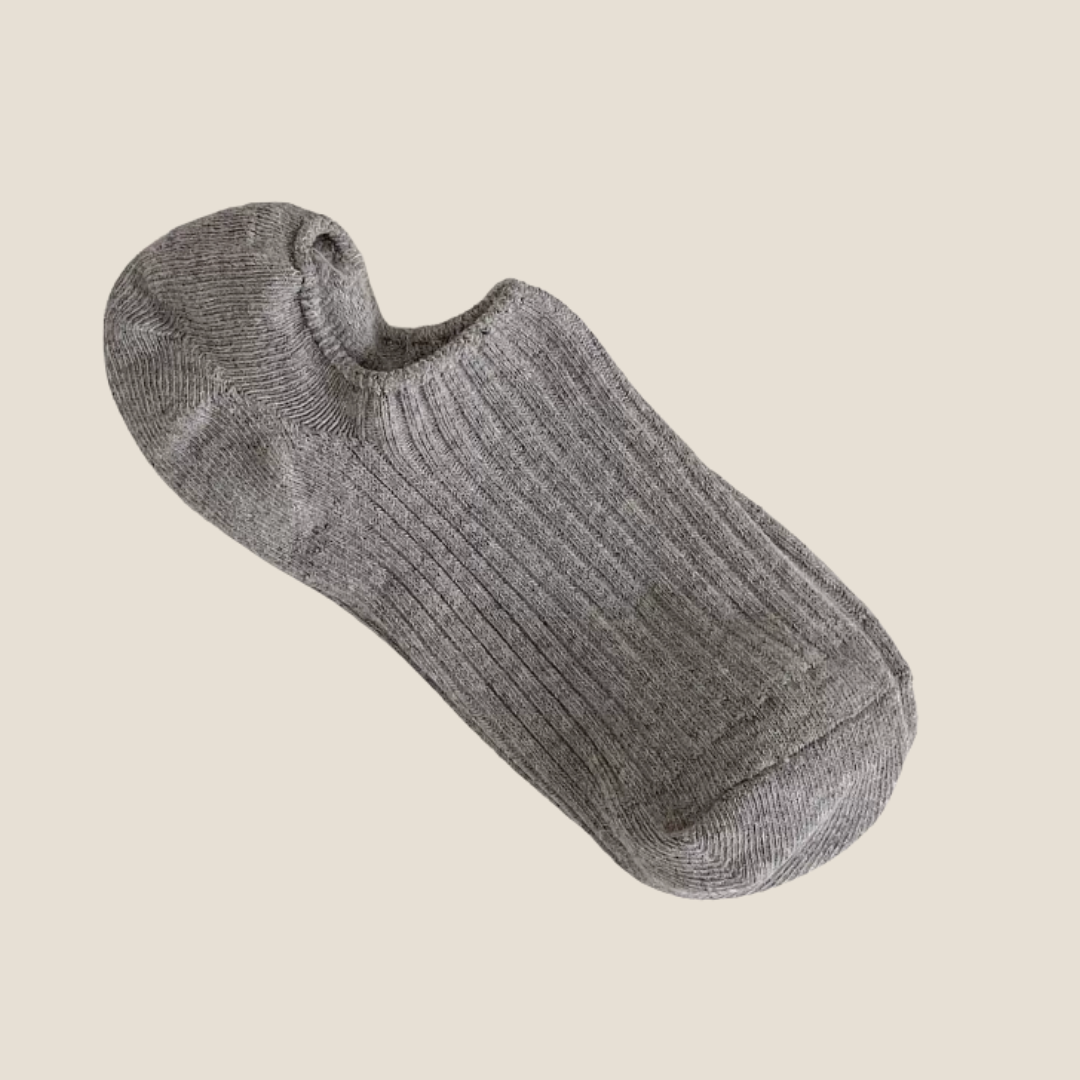 Women's cotton ankle socks in grey, featuring a fine ribbed knit. Displayed flat on a light surface.